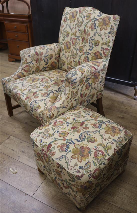 A George III style upholstered armchair and a footstool